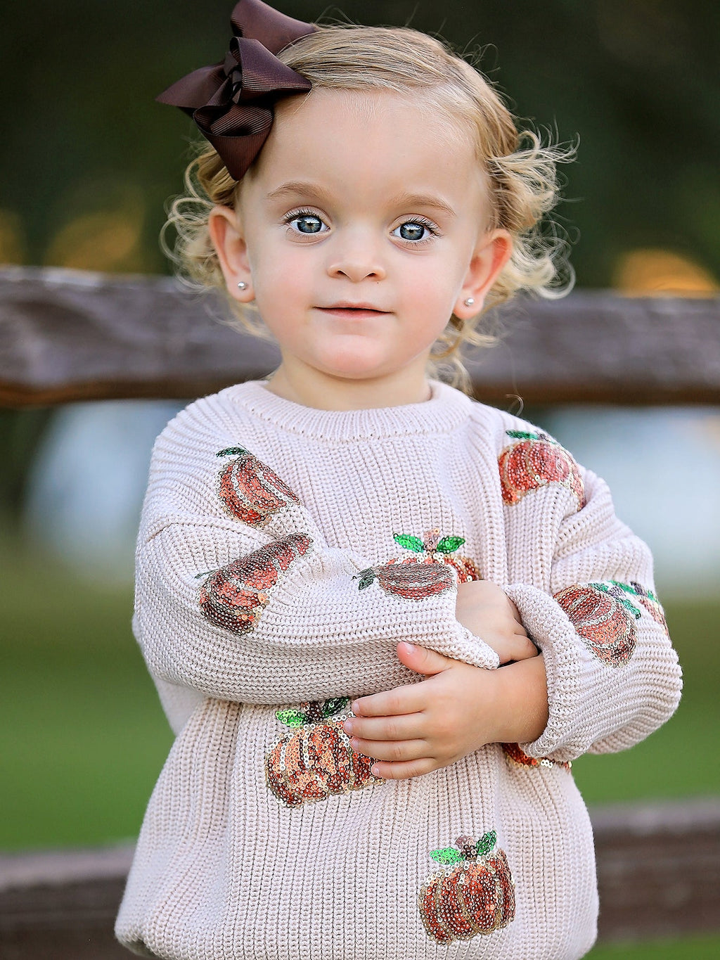 Kids beige knit sweater with sequined pumpkin designs and ribbed hem