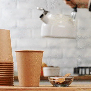 Unbleached kraft hot coffee cup on wooden table with stacked cups behind