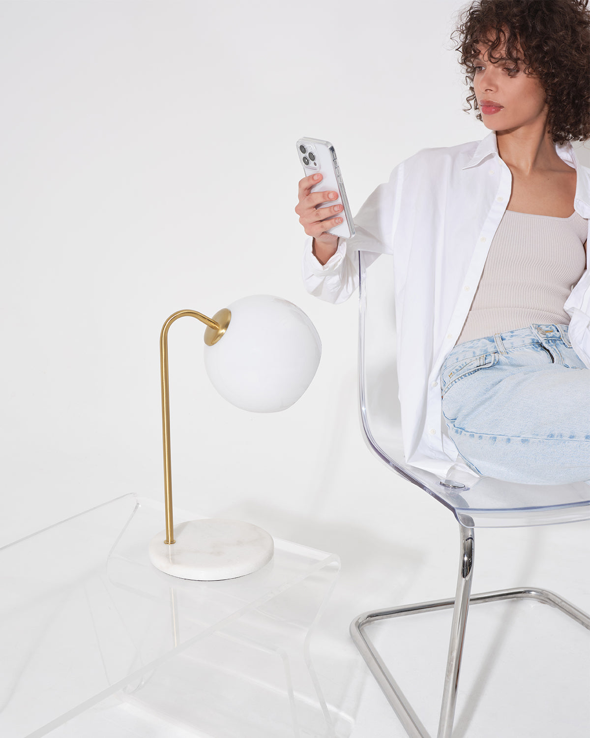 Krystal table lamp with round opal shade and gold stand, on white base