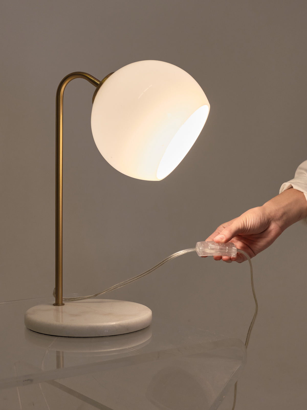Krystal table lamp with round opal shade, gold stem, and power cord