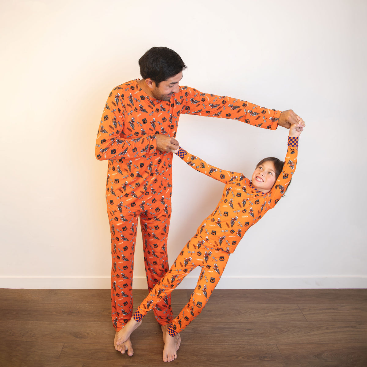 Orange racing-print adult pajama set with long sleeves and full-length pants