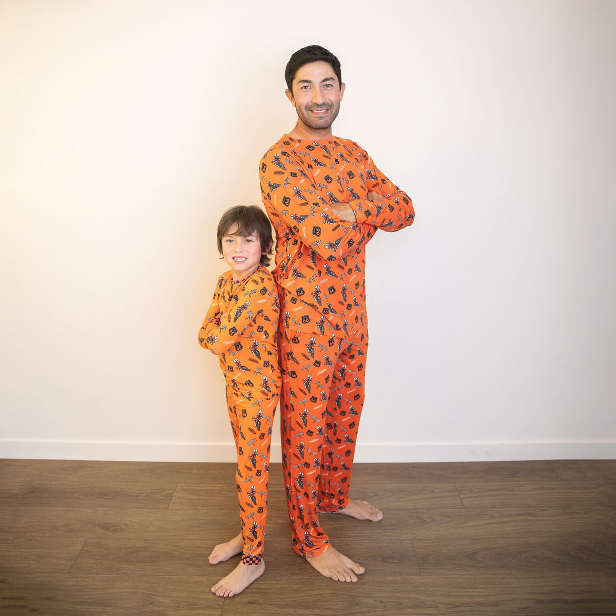 Adult orange long-sleeve pajama set with racing print, worn with matching child