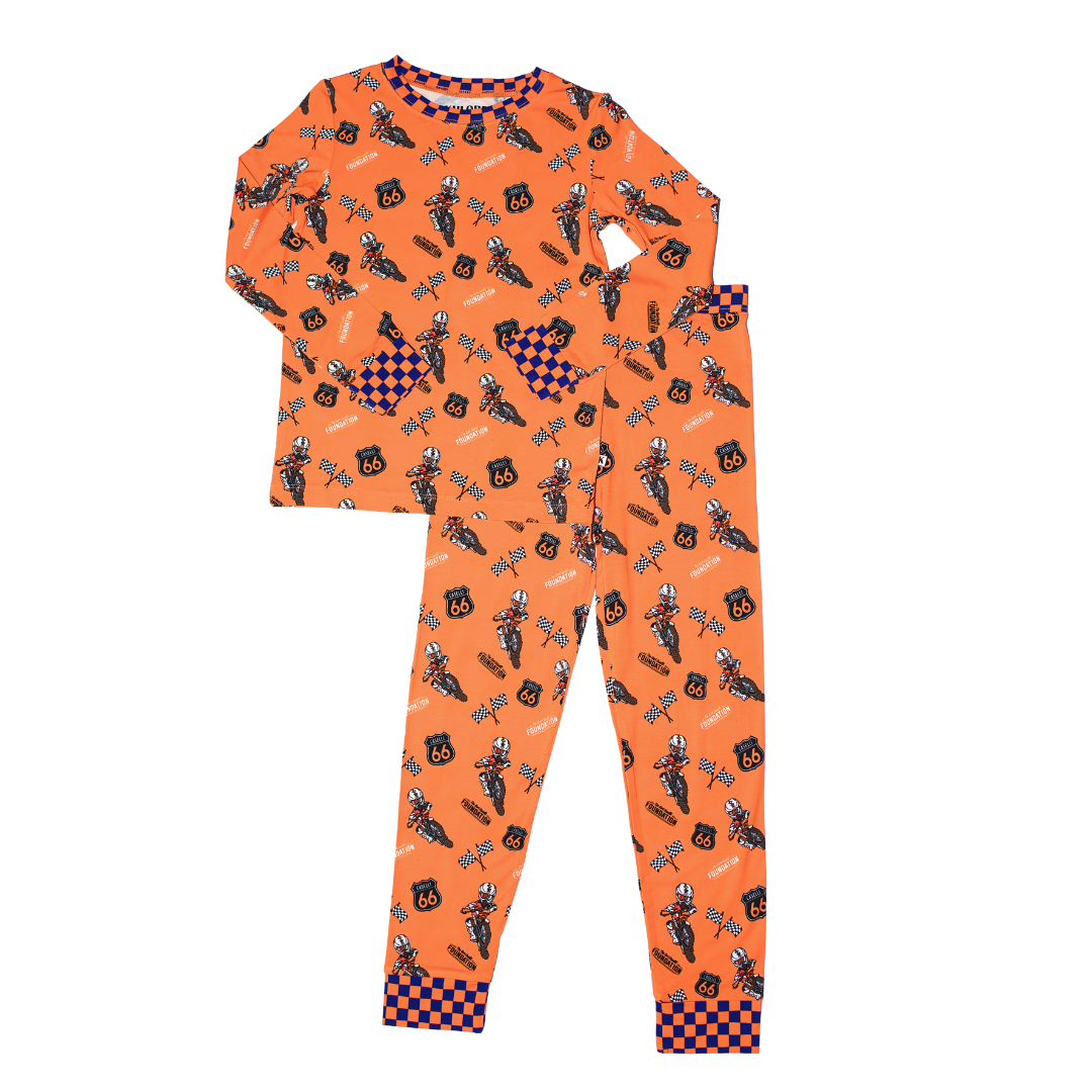 Orange two-piece pajama set with long sleeves; racing moto print and check cuffs