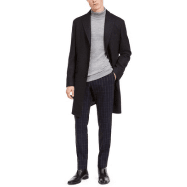 Men's slim-fit dark overcoat over knit sweater, notched lapel