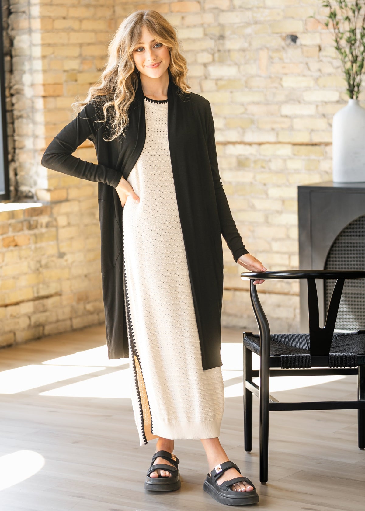 Open-front long cardigan in black with long sleeves and visible trim detail