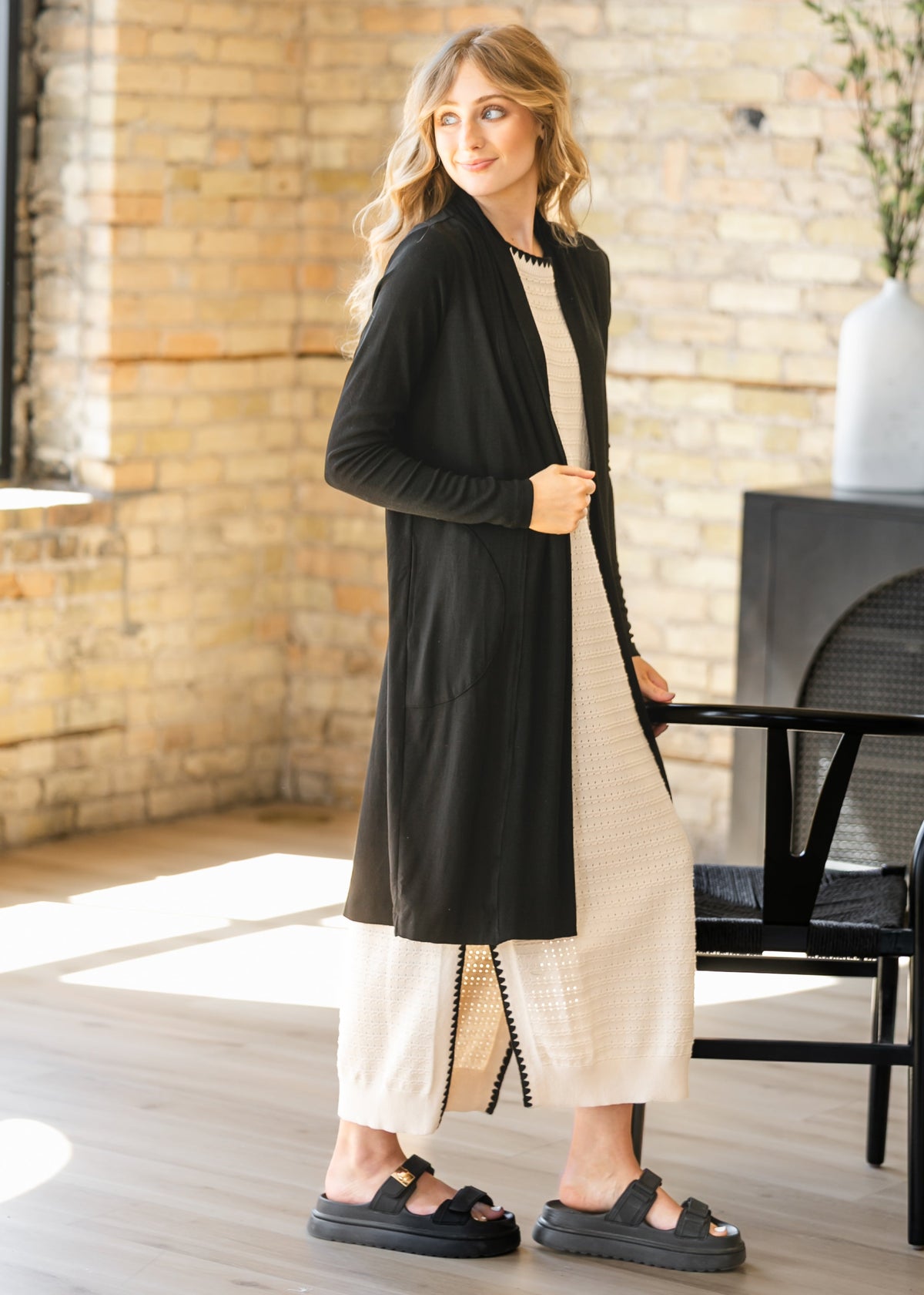 Open-front long black cardigan with long sleeves and side pockets