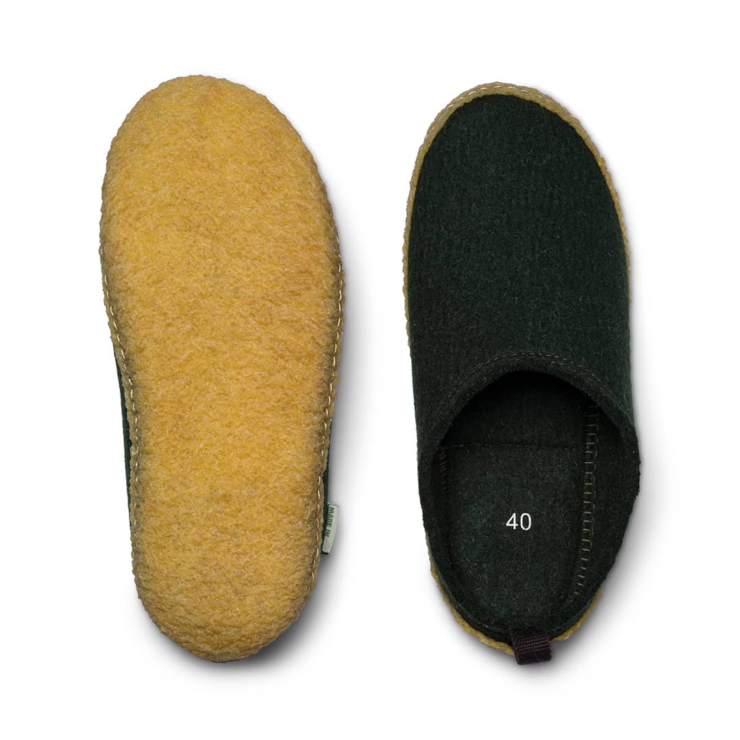 Outdoor wool slides close-up: yellow outer and dark green inner footbed