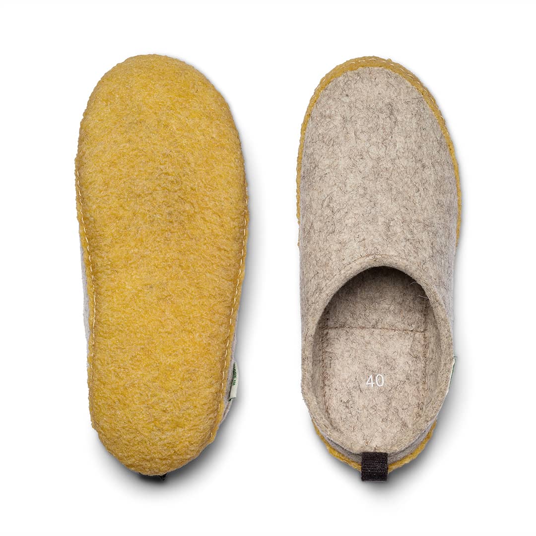 Outdoor wool slide pair close-up: yellow upper and light gray inner lining