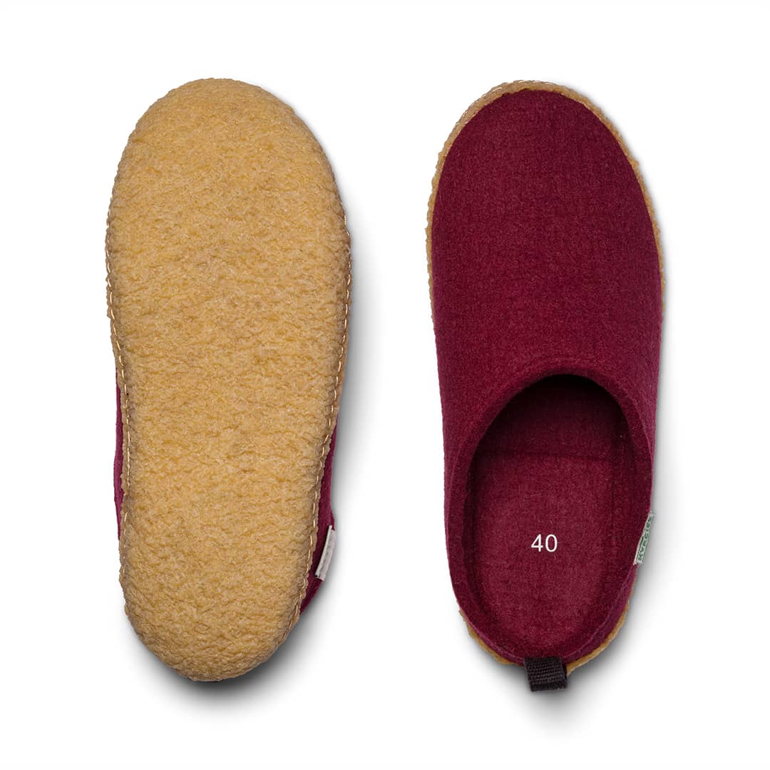 Outdoor wool slides close-up: yellow upper and deep magenta inner lining