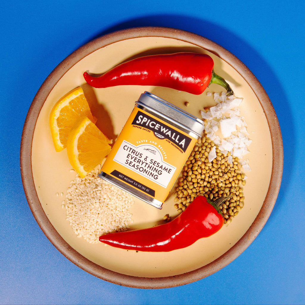 Seasoning tin with citrus and sesame spice blend on a plate