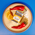 Seasoning tin with citrus and sesame spice blend on a plate