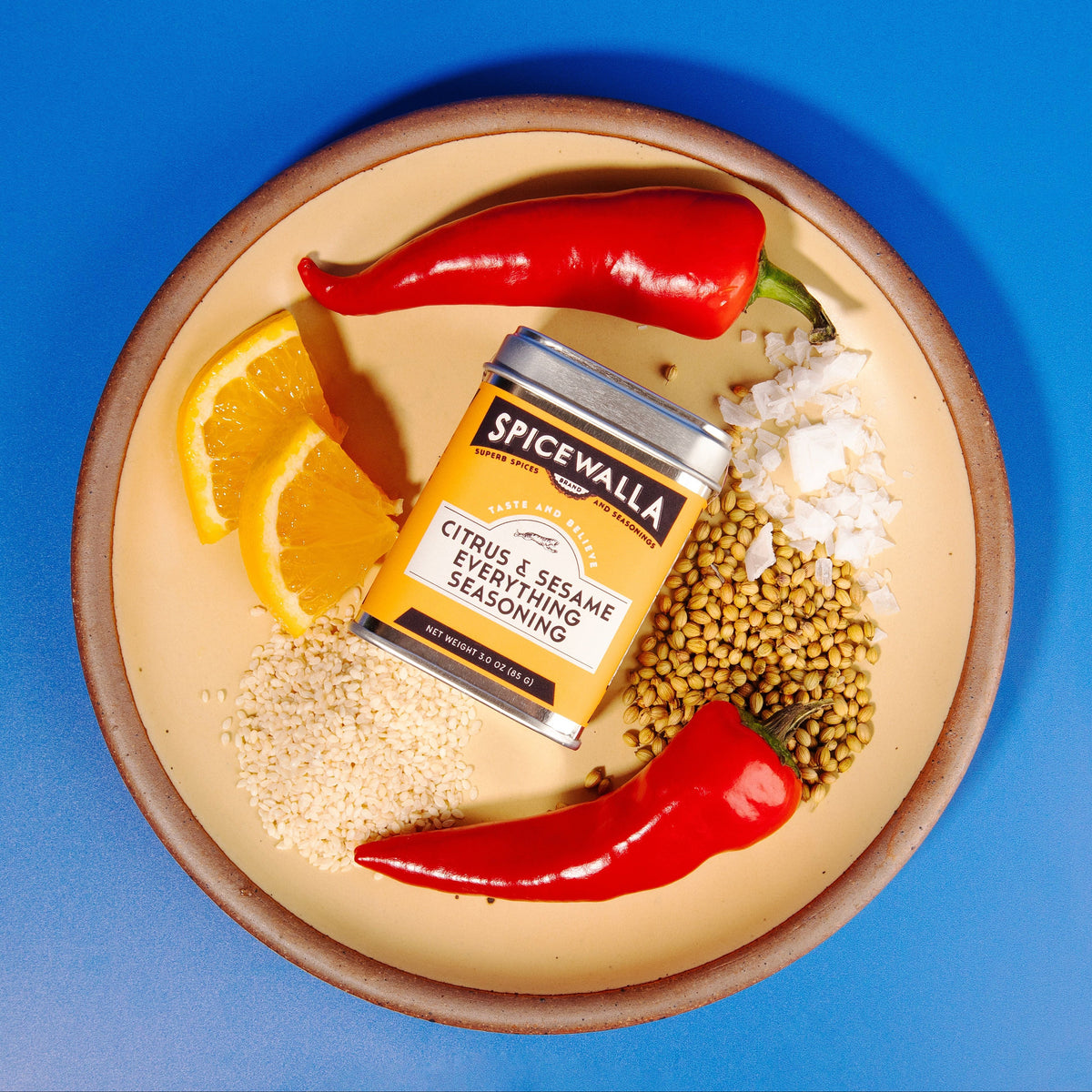 Seasoning tin with citrus and sesame spice blend on a plate