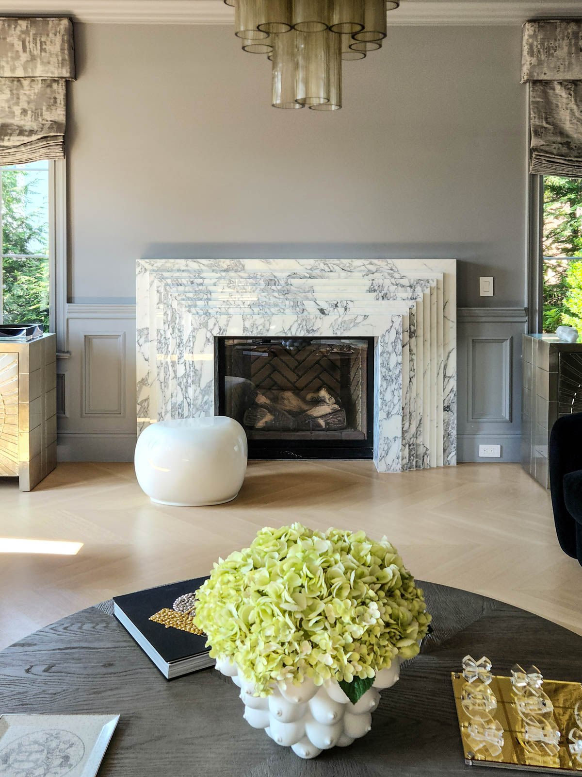 Marble fireplace surround with black firebox and visible flames, set in a living room