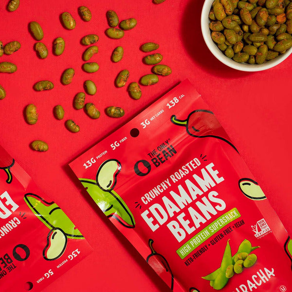 Crunchy roasted edamame snack pouch with visible green edamame seeds, sriracha