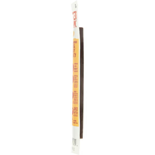 Smoked turkey stick end view, dark brown sausage stick in wrapper