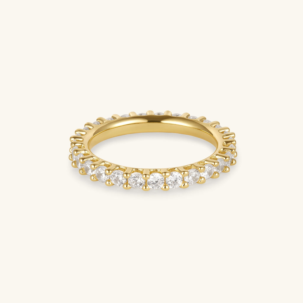 Gold eternity ring with round prong-set stones along the band
