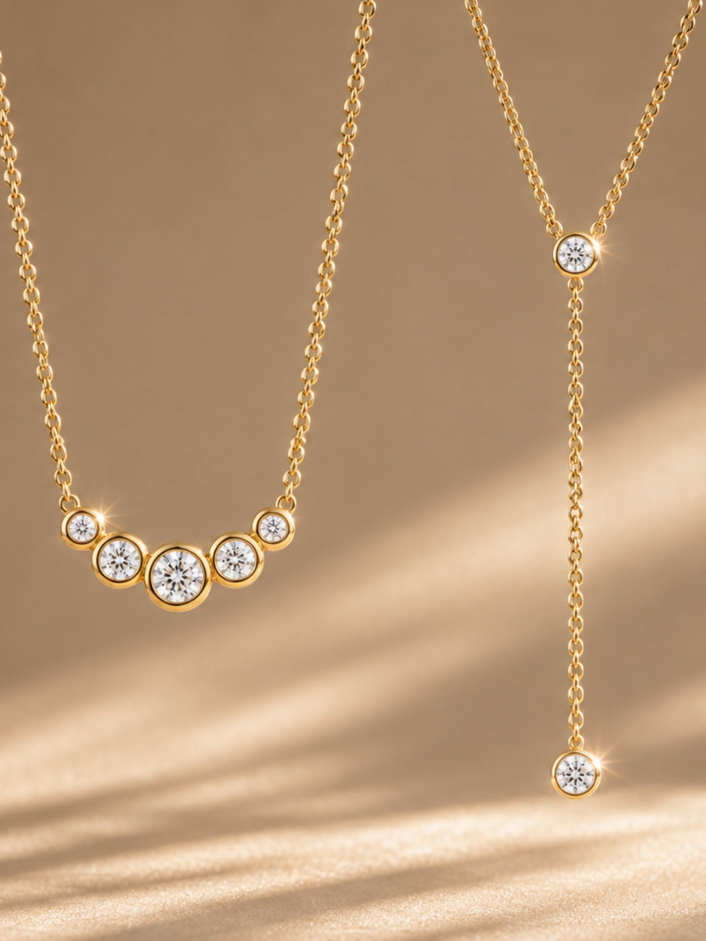 Gold-tone lariat necklace with arched row of five round bezel stones