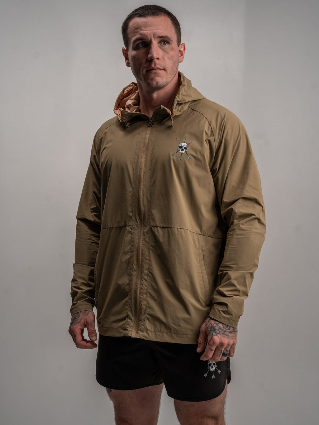 Men's olive Journey jacket worn over a t-shirt with hood and zip front