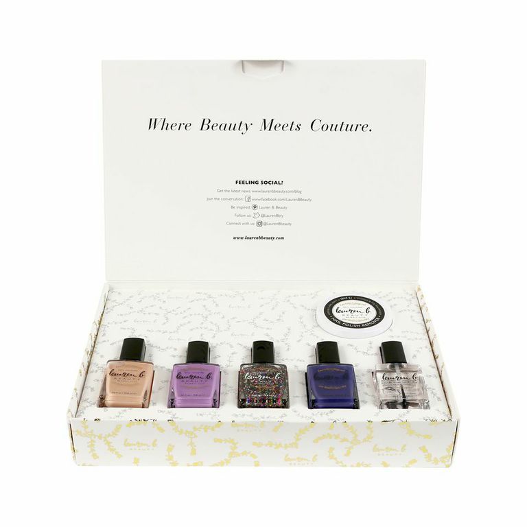 Open nail polish collection box with five bottles and round polish remover jar
