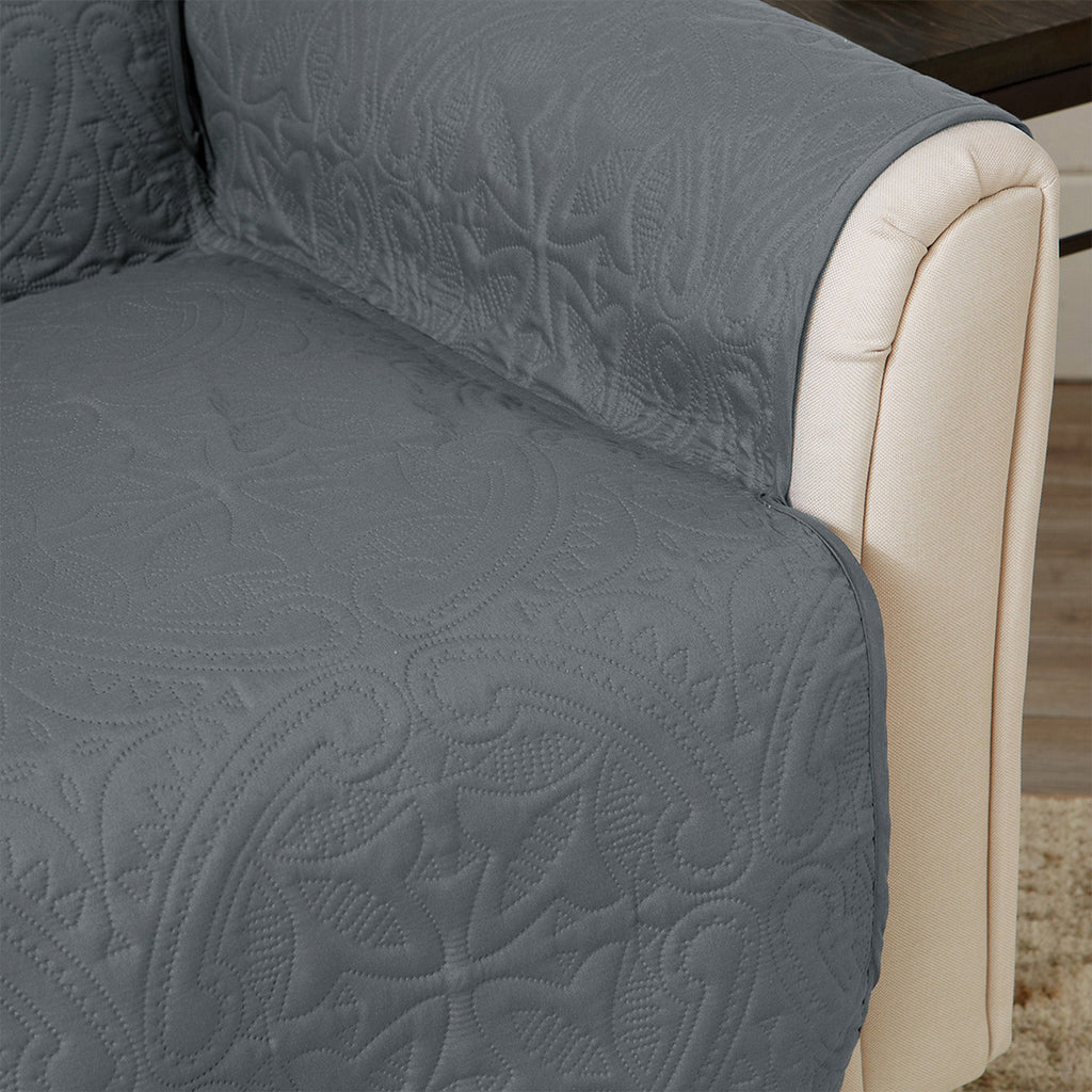Upholstered furniture protector with dark blue patterned quilted fabric and light trim