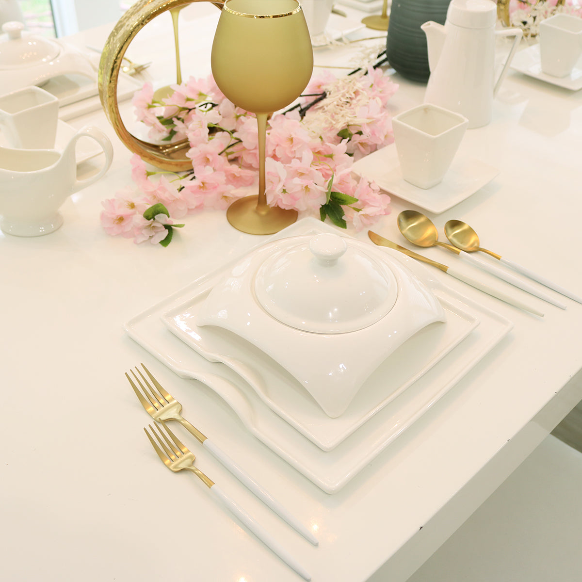 White porcelain square plates, lidded dish, and small cup for serving