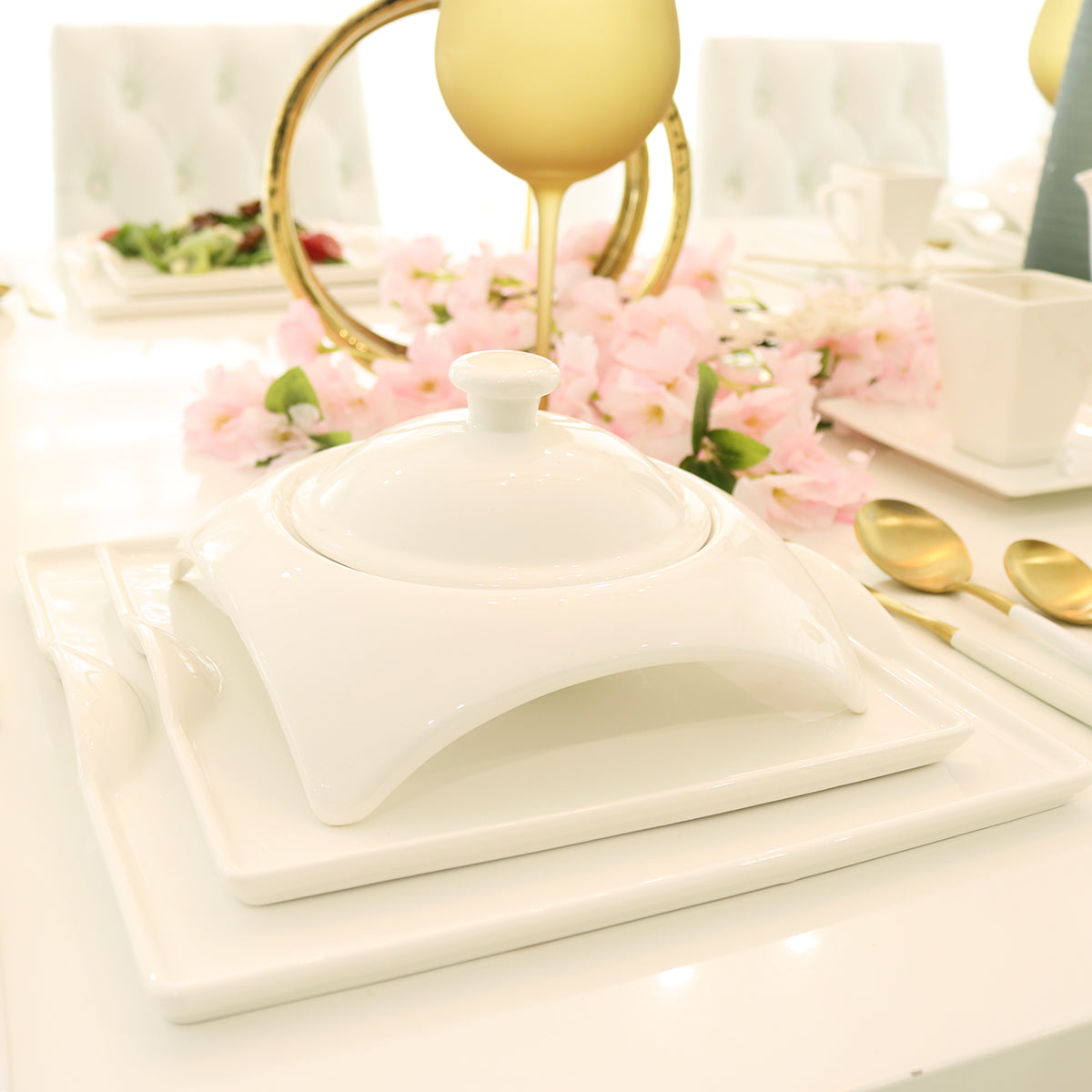 White porcelain covered tureen with lid finial on a square base tray
