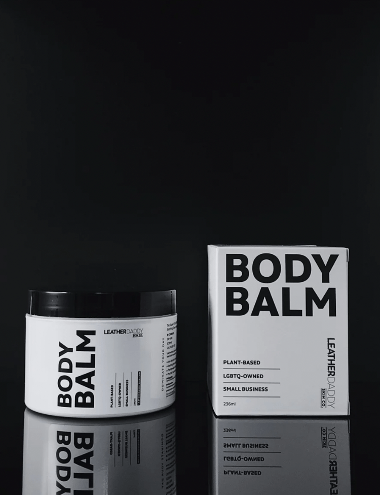 LeatherDaddy body balm jars with 'BODY BALM' labels, white jar and black text