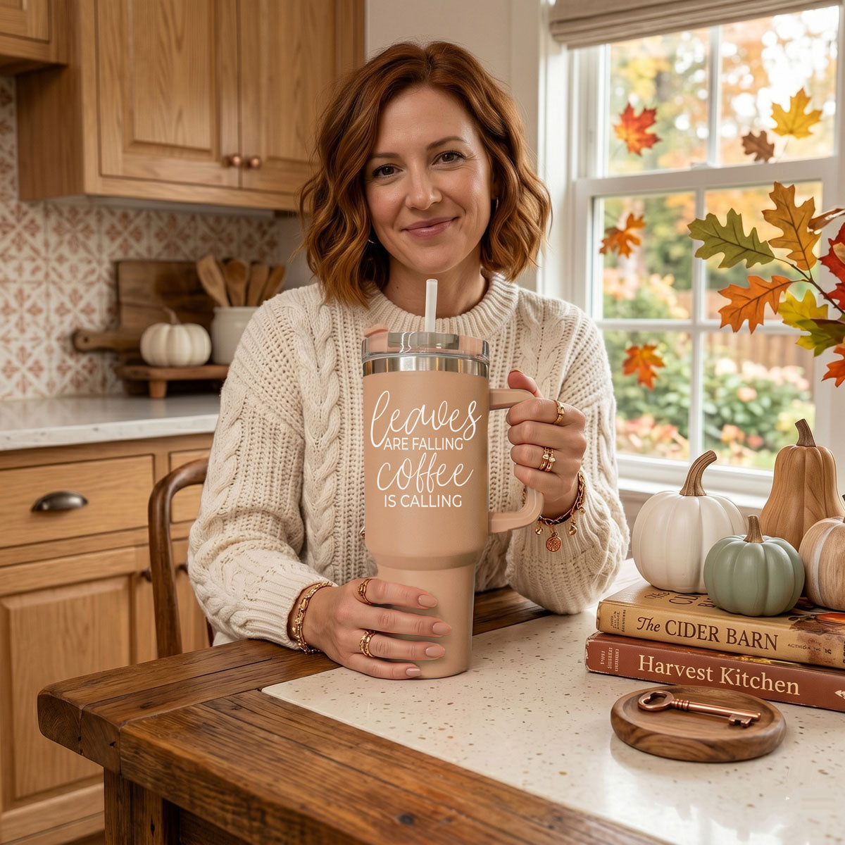Taupe 40oz travel tumbler with clear lid and straw, rose handle, held by smiling woman