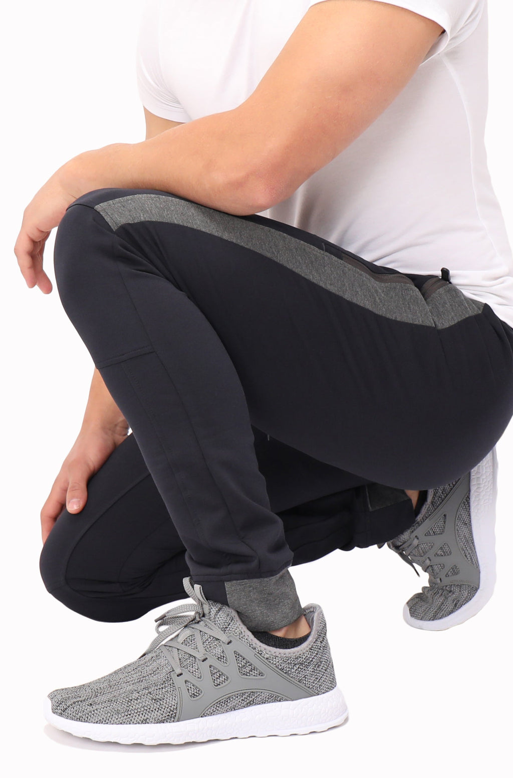 Tall fit jogger pants in dark black with grey side stripe and elastic ankle cuffs.