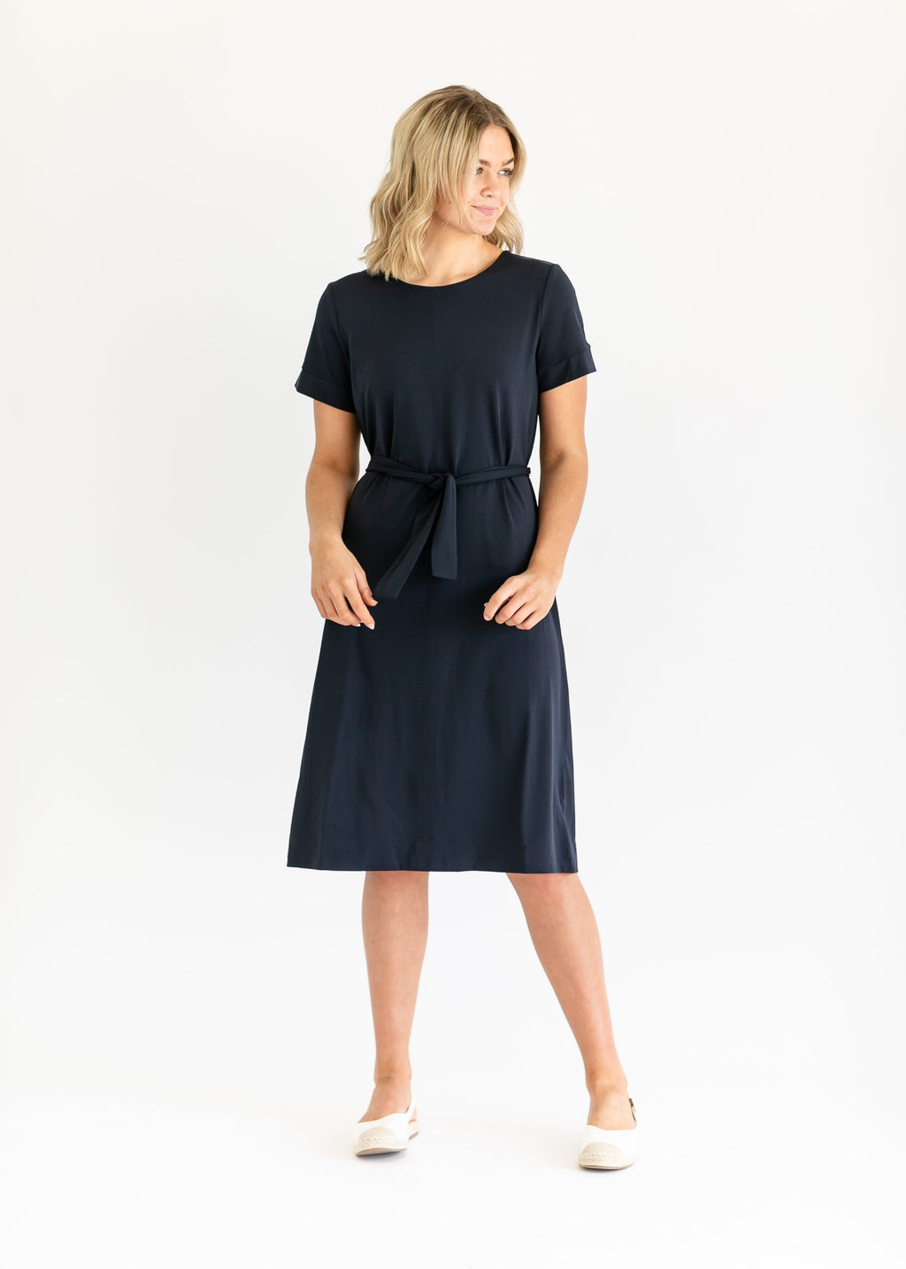 Navy midi dress with short sleeves and waist tie belt, full-length studio view