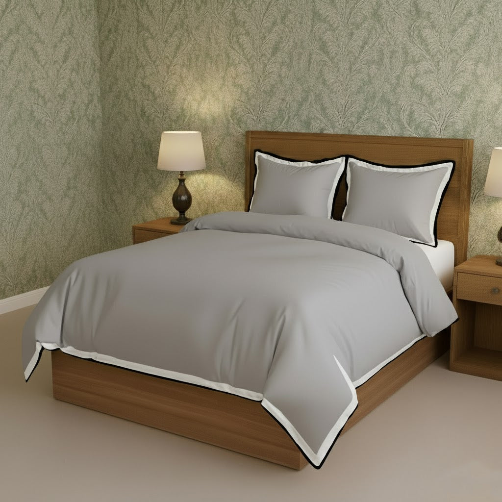 Light gray duvet cover set with white border frame and matching pillowcases