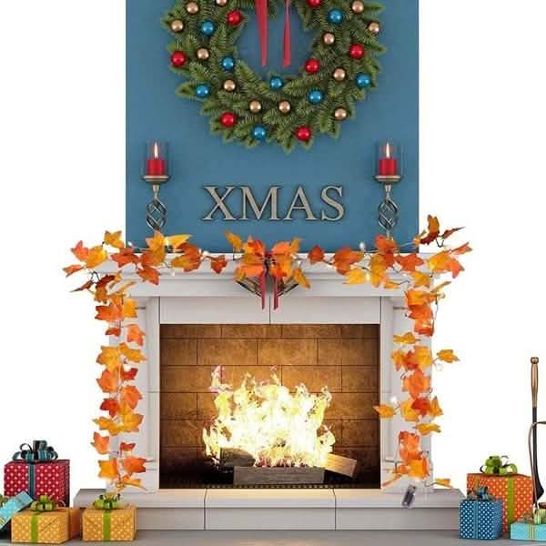 Lighted fall leaf LED string lights around a fireplace mantle with glowing orange leaves