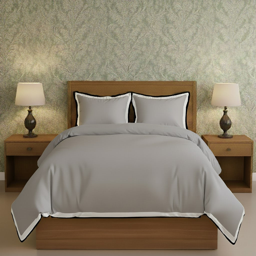 Light gray duvet cover set with white border frame and matching pillow shams