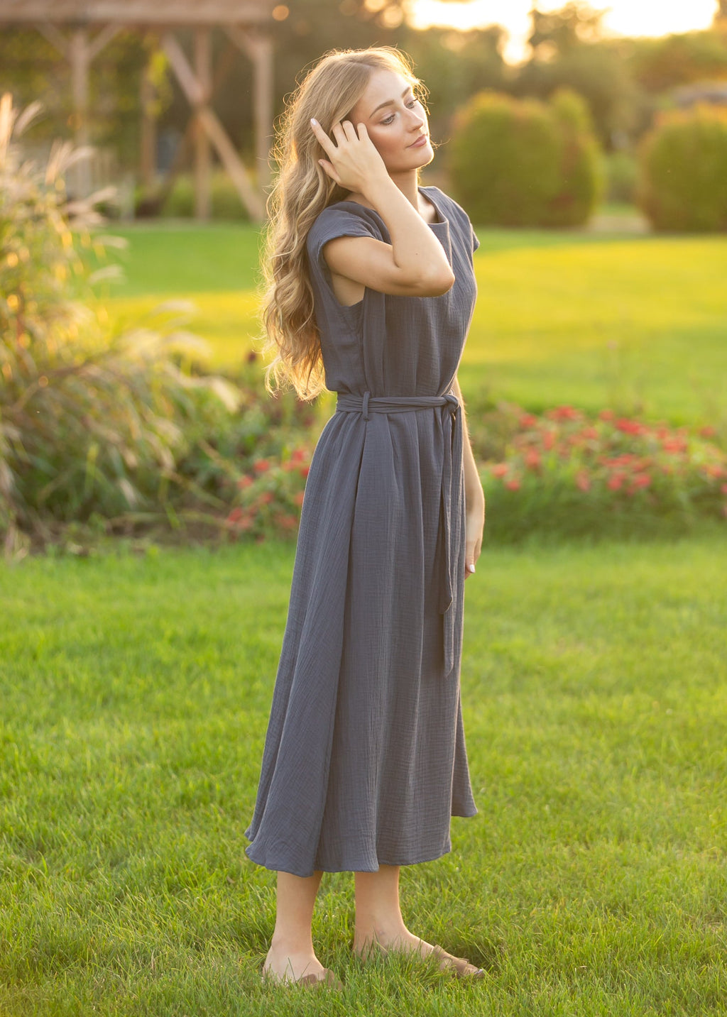 Navy belted midi dress with short sleeves and tie waist, side view