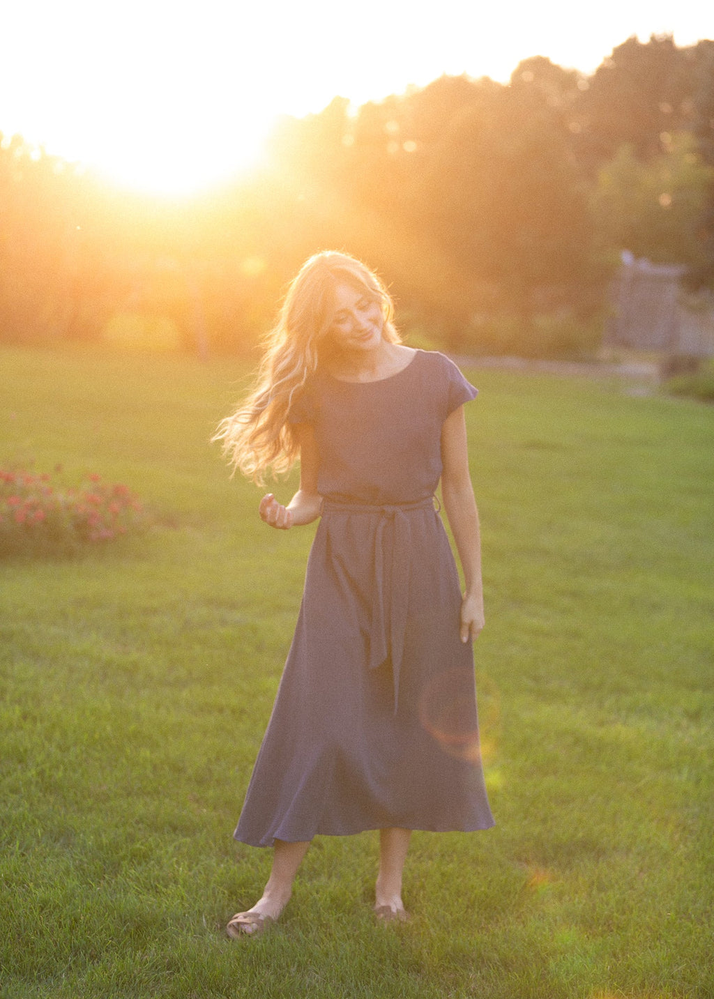 Navy belted midi dress with short sleeves and flowing gathered skirt