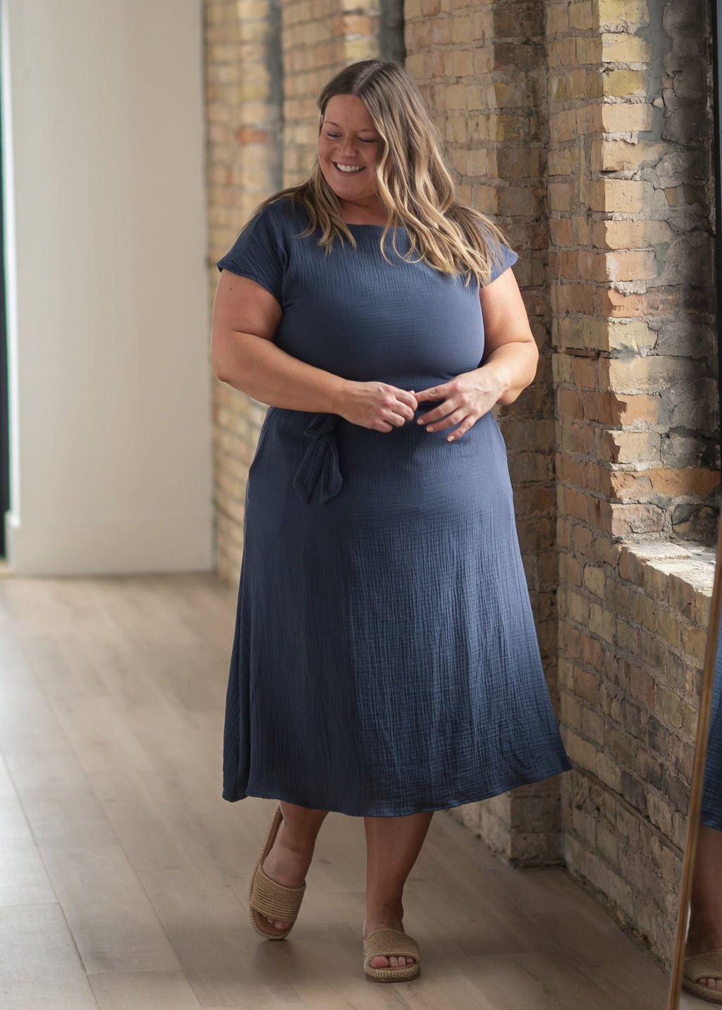 Navy belted midi dress with short sleeves and draped, gathered skirt