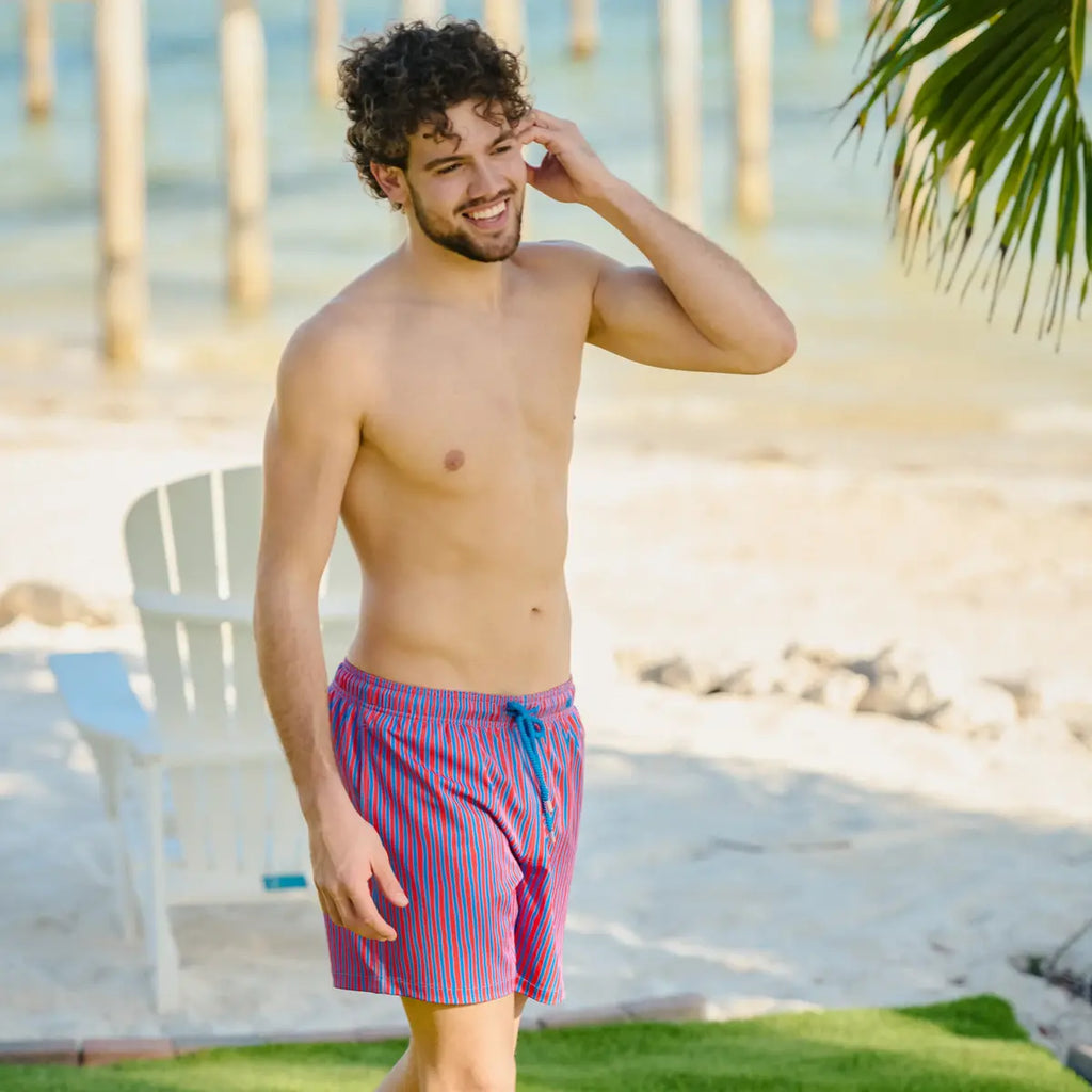 Red striped swim trunk on model, blue drawstring, above-knee length