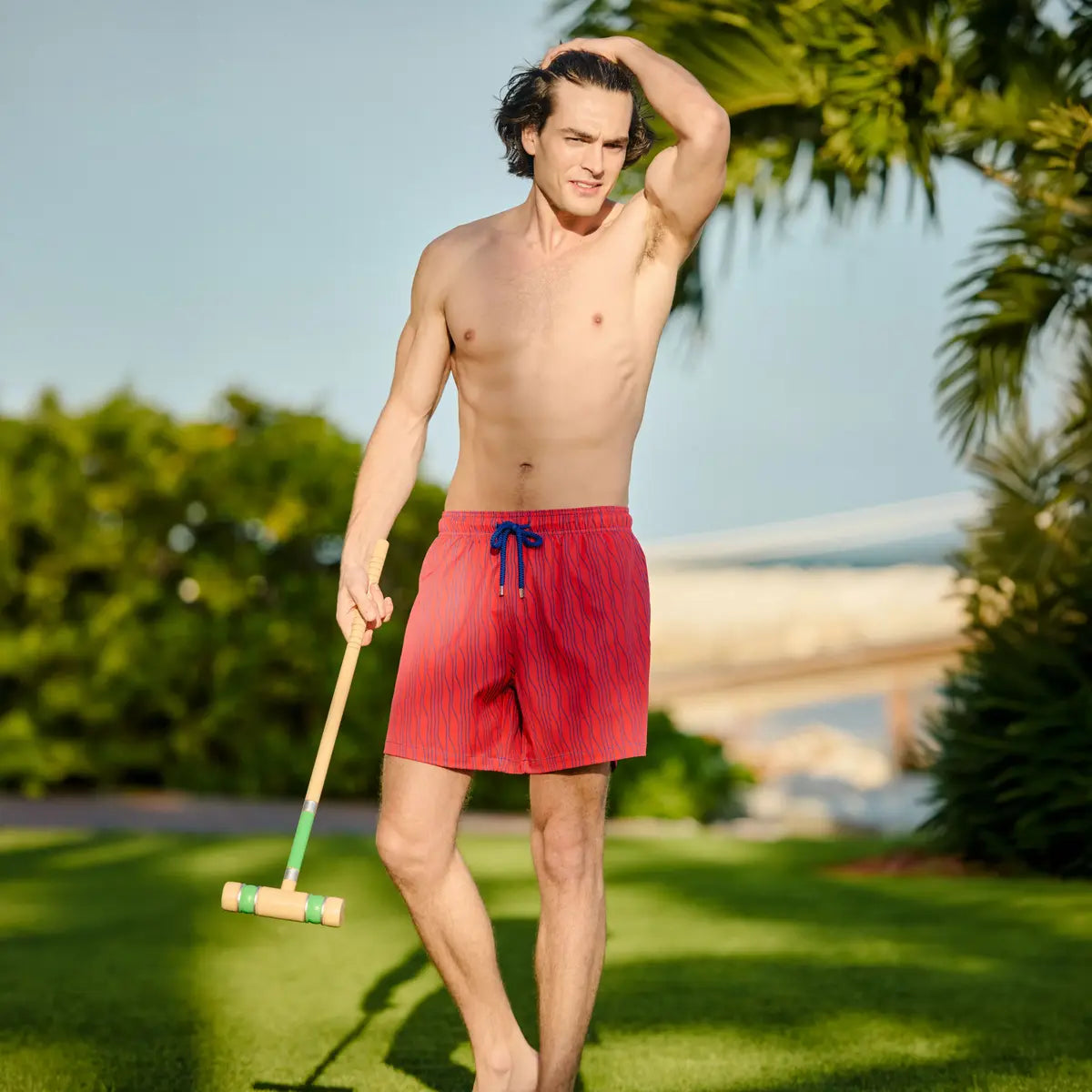 Red striped swim trunk with blue drawstring and elastic waistband, front view