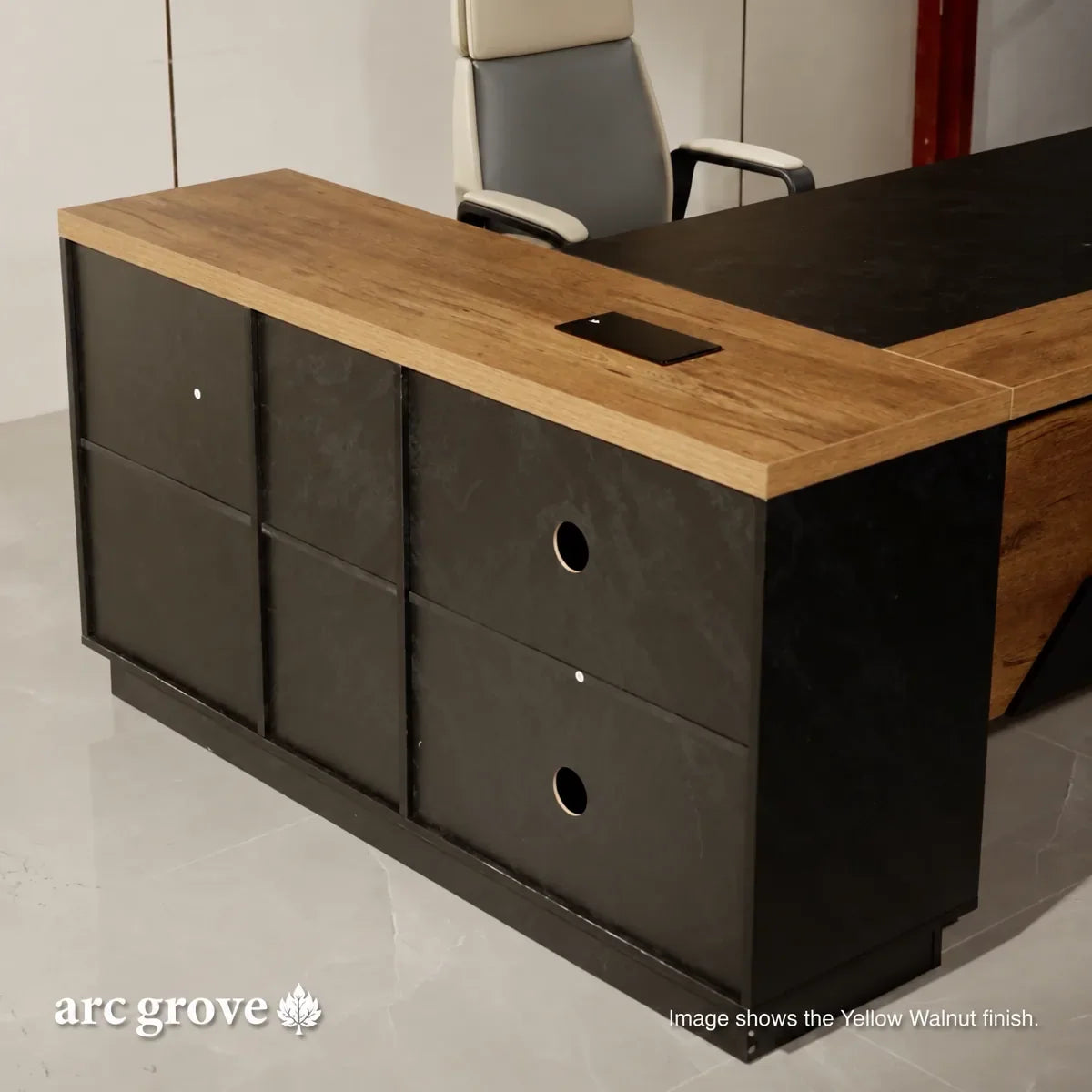 L-shaped executive desk with light wood top and dark gray return, built-in grommet