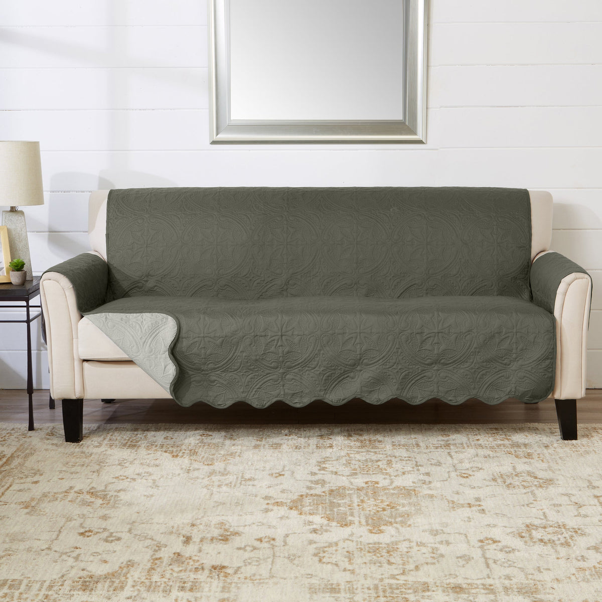 Sofa protector cover in sage green with textured pattern and cream arm panels