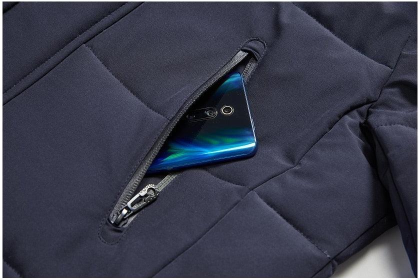 Dark blue front pocket with zip opening holding a smartphone