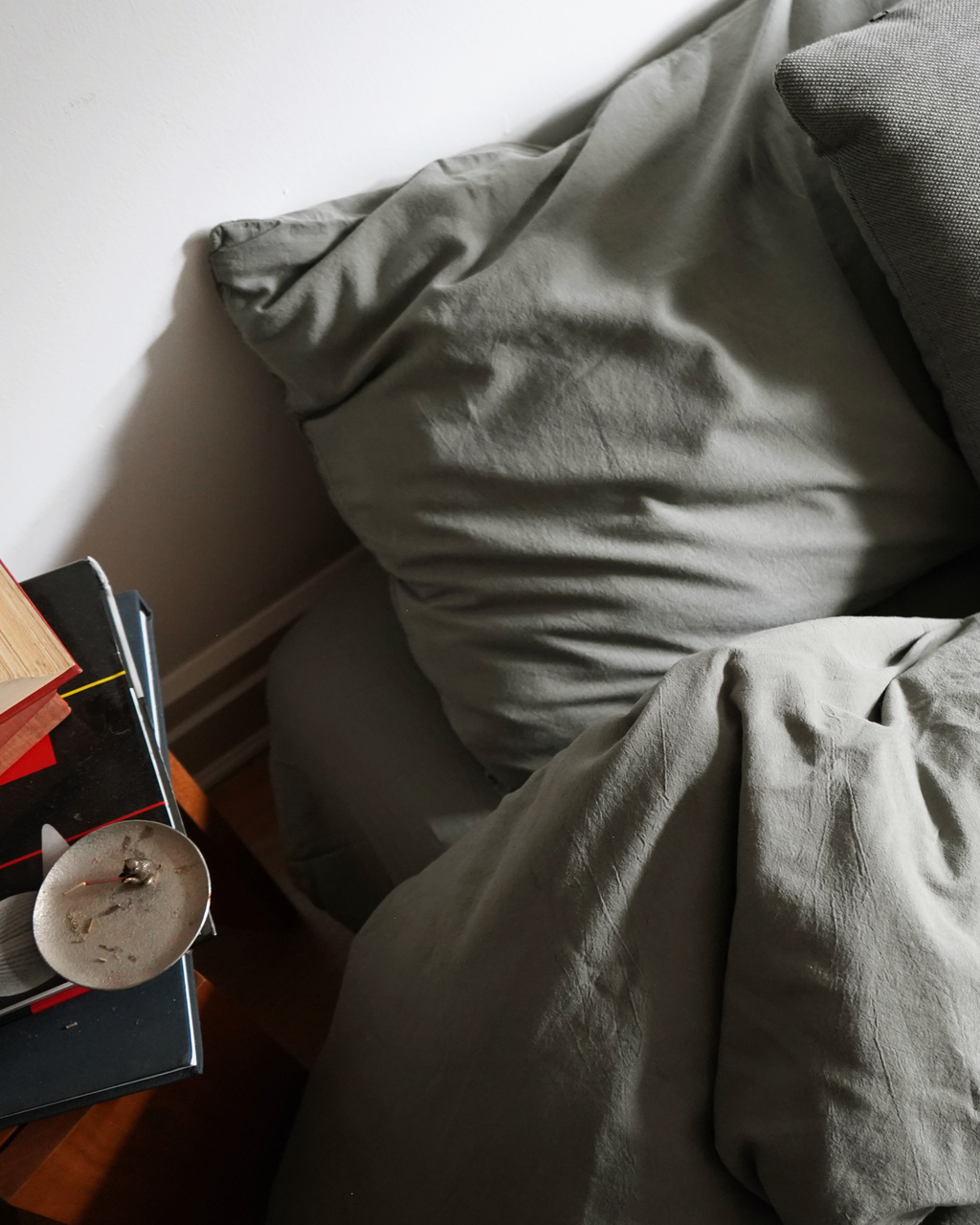 Gray duvet cover with folded bedding fabric on a bed