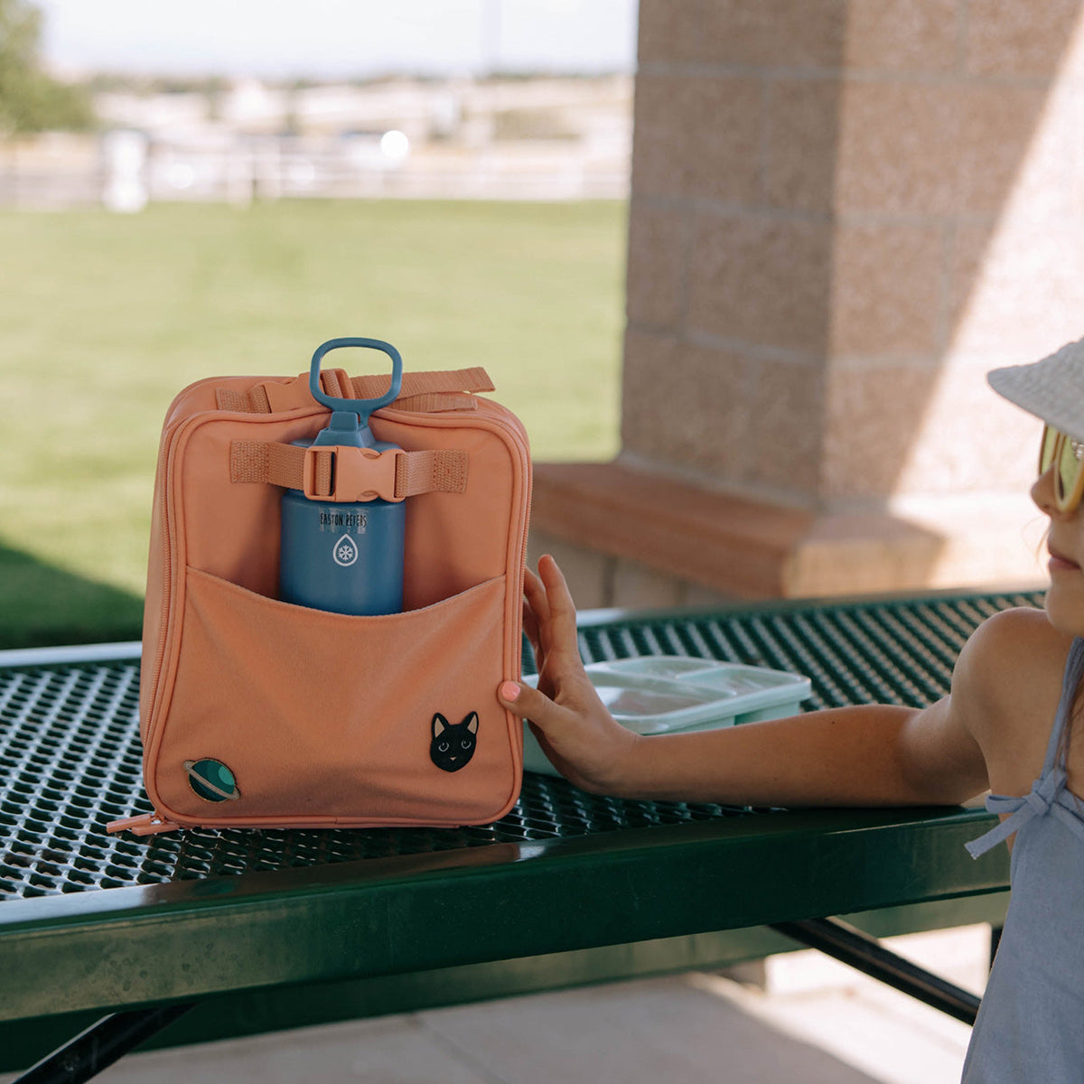 Orange insulated lunch box with front cat patch and blue water bottle holder