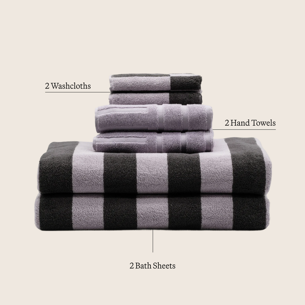 Lilac and dark striped cotton towel stack with folded washcloth and hand towel layers