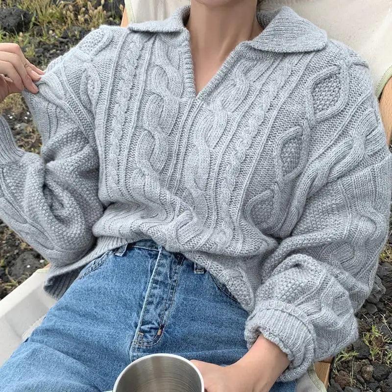 Gray-blue cable knit sweater with turn-down collar, worn with blue jeans