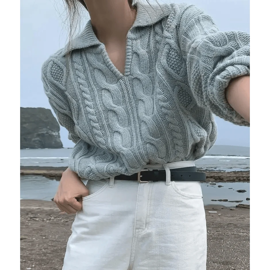 Gray-blue cable knit sweater with turn-down collar, worn with white pants