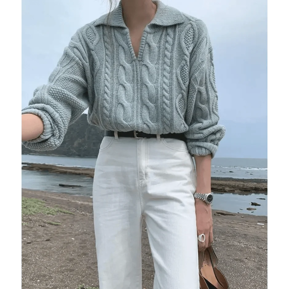 Gray-blue cable knit sweater with turn-down collar, worn with white pants