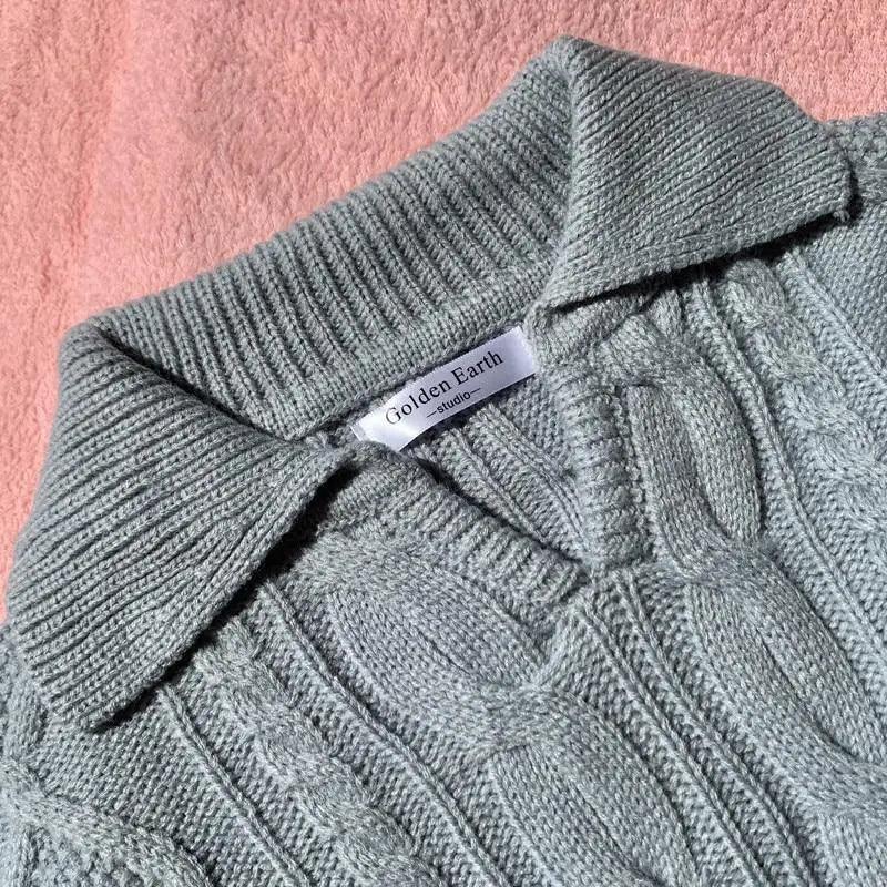 Gray knit sweater collar and V-neck placket with cable pattern detail