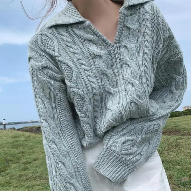 Gray-blue cable knit sweater with turn-down collar and textured cable pattern