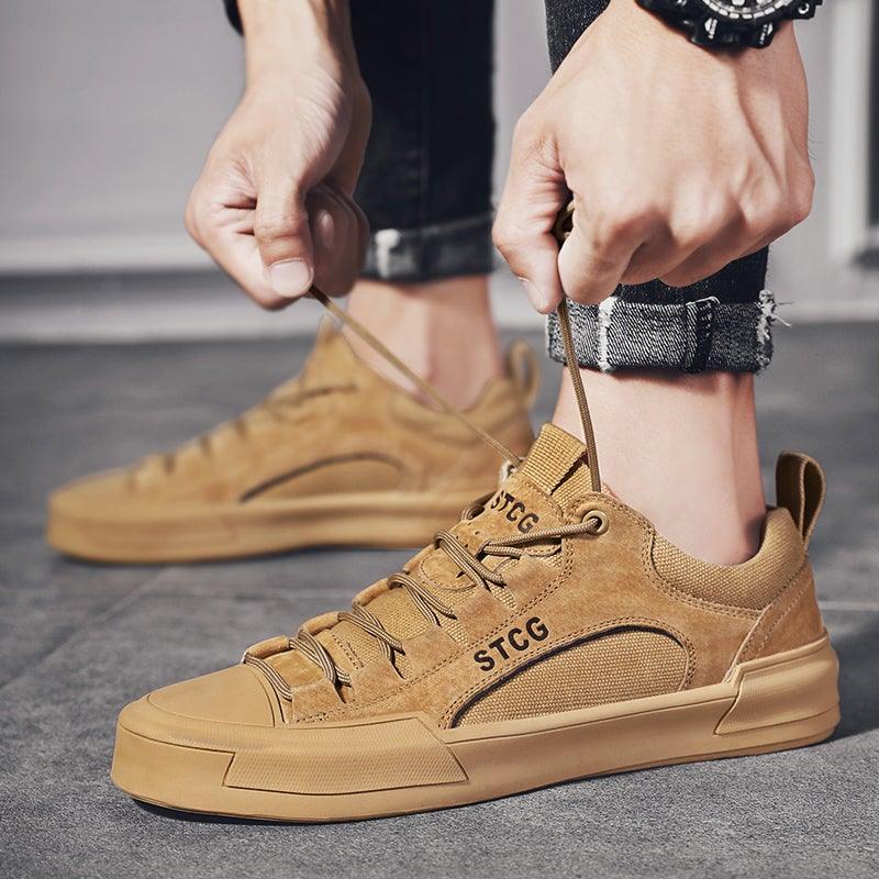 Men’s tan lace-up sneakers with textured upper and rubber sole, laces visible